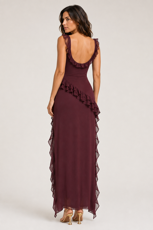 Back view of a woman wearing the dark red asymmetric ruffle maxi dress, showing the low back