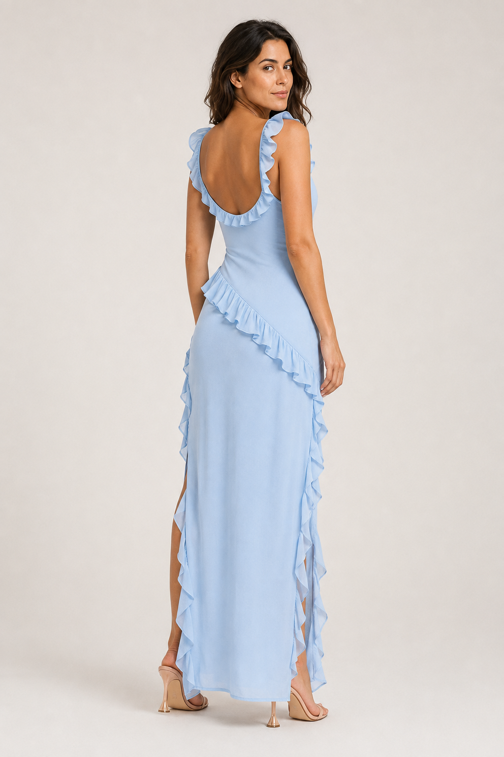 Back view of a woman wearing the light blue asymmetric ruffle maxi dress, showing the low back