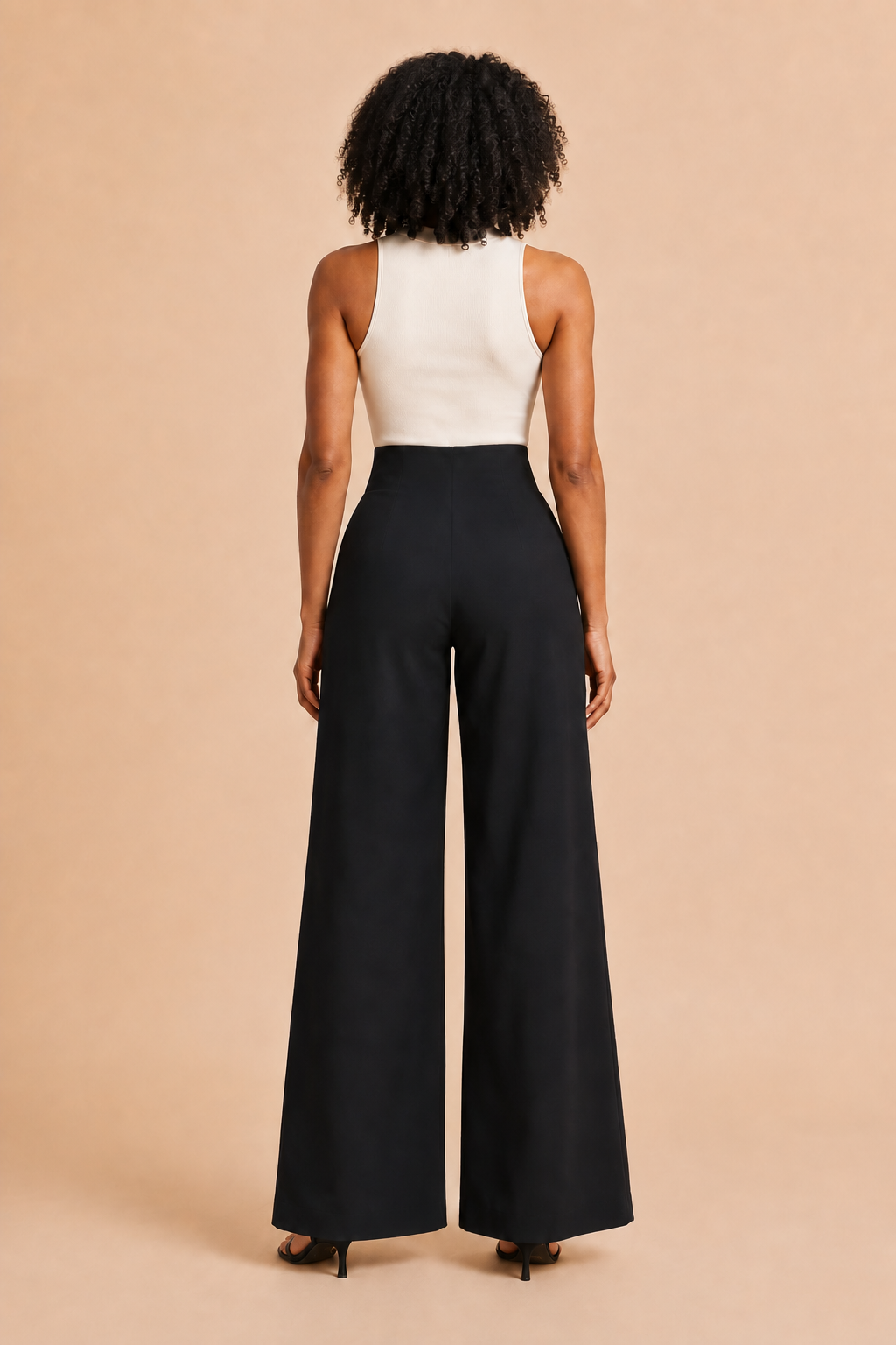Back view of the black high-waist wide-leg trousers with a smooth closure-free waistband