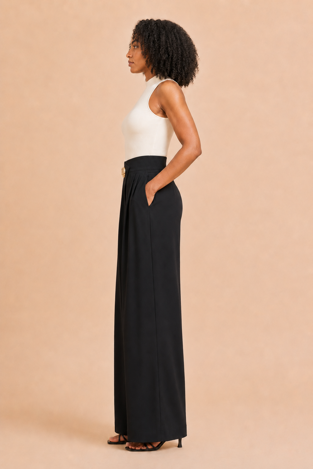 Left-side view of the black asymmetric high-waist wide-leg trousers showing the side pocket