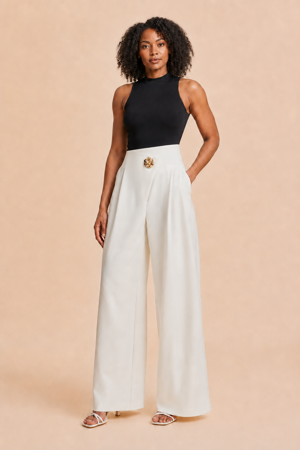 Woman wearing the white asymmetric high-waist wide-leg trousers, front three-quarter view