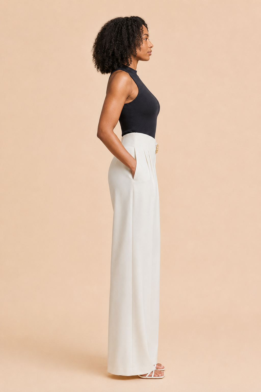 Left-side view of the white asymmetric high-waist wide-leg trousers showing the side pocket