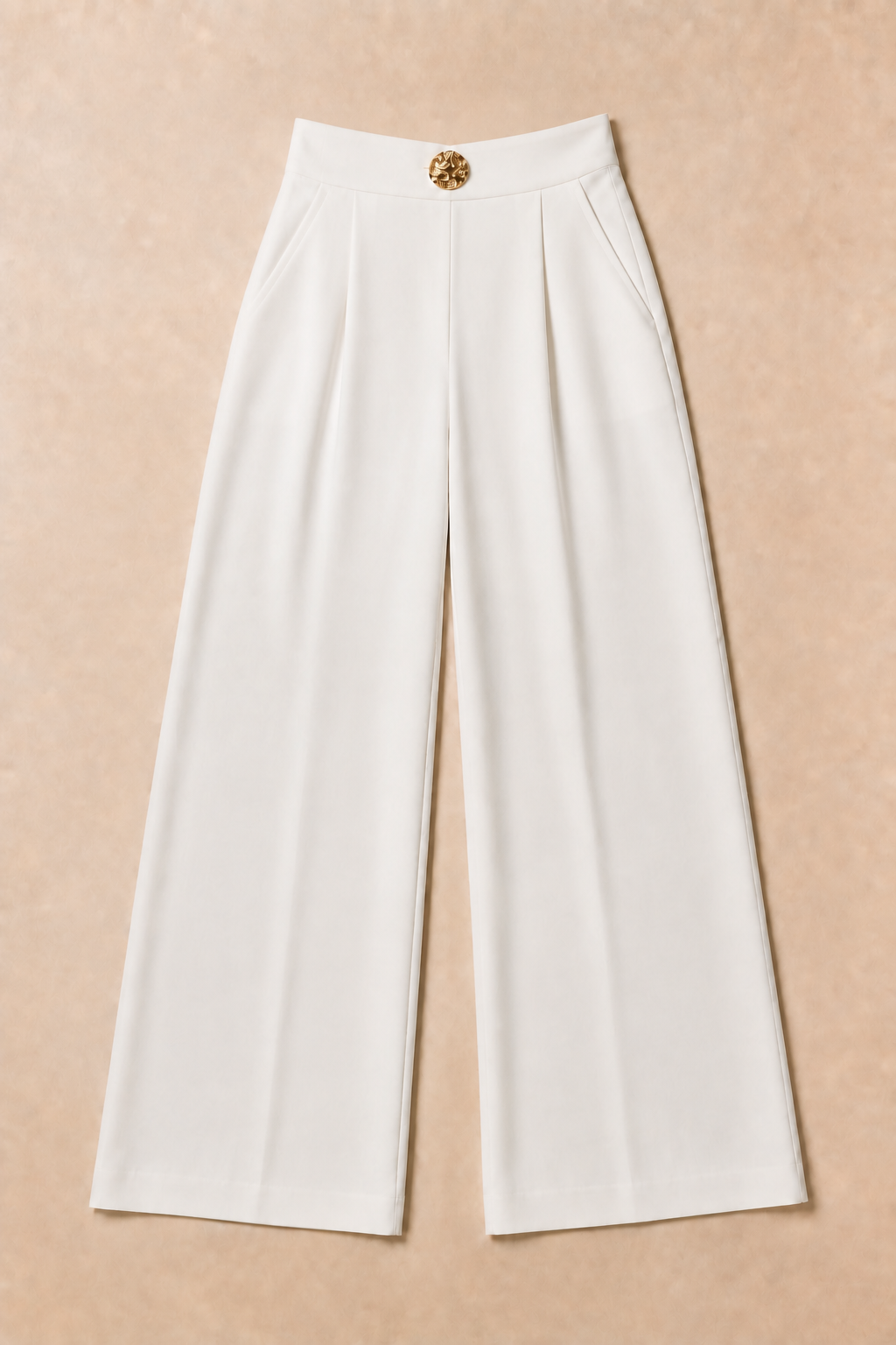 Flat-lay of the white wide-leg trousers showing the small V-shaped waistband