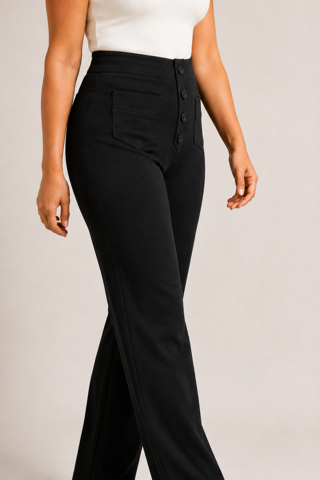 Model-worn close-up of the black trousers showing the fine matte fabric texture and tonal stitching