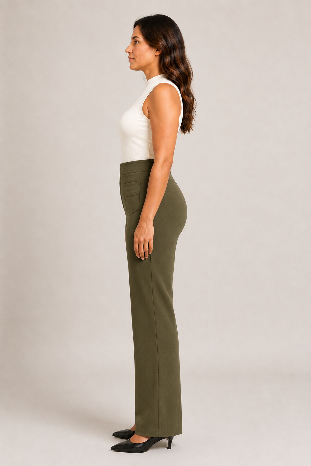 Side view of the green high-waisted straight-leg trousers showing the fitted waist and full-length silhouette