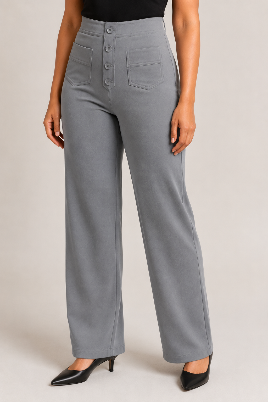 Model-worn close-up of the grey trousers showing the fine matte fabric texture and tonal stitching