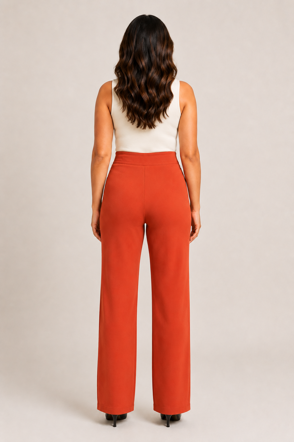Back view of the orange high-waisted straight-leg trousers showing the clean waistband and straight legs