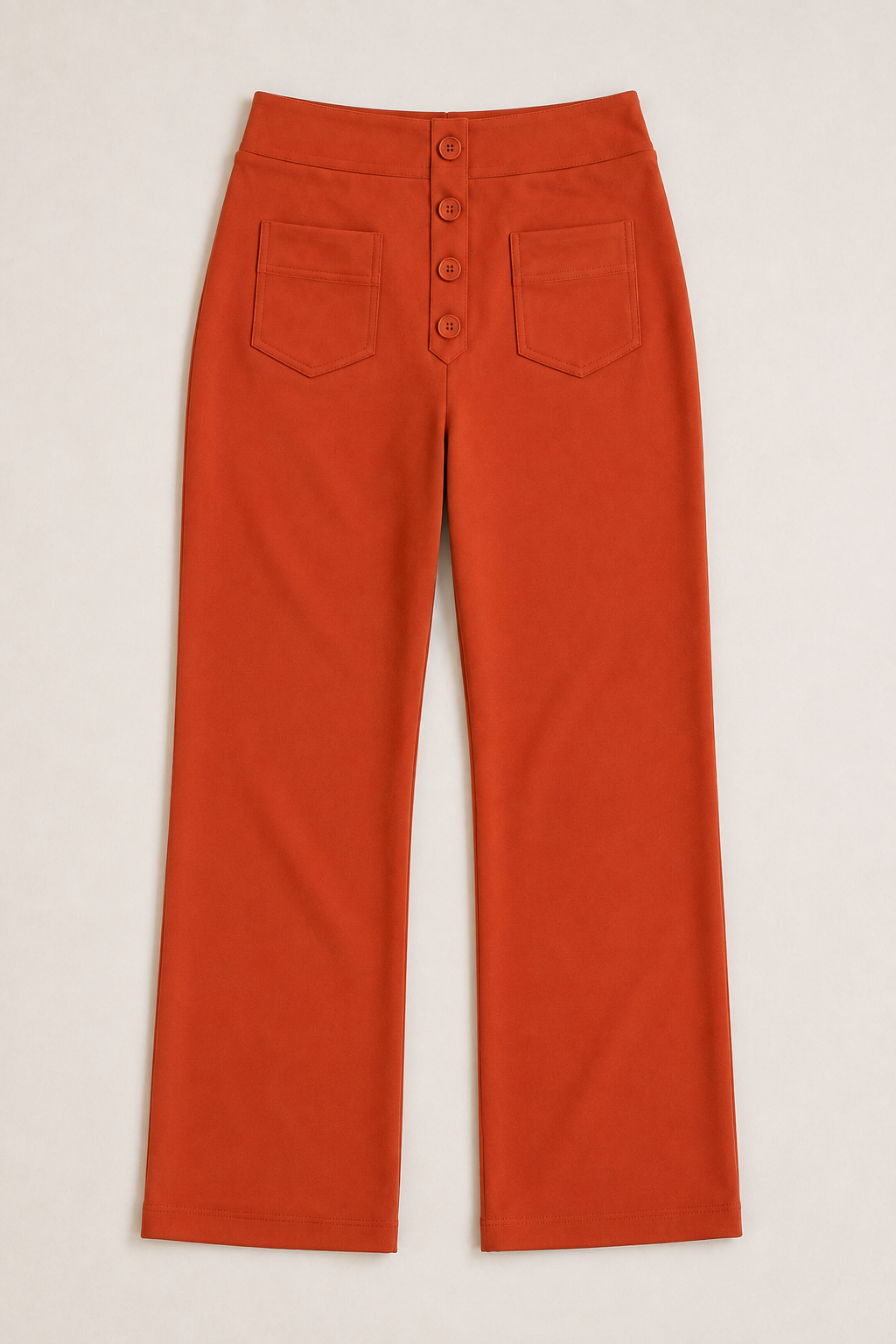 Flat-lay of the orange button-front high-waisted straight-leg trousers