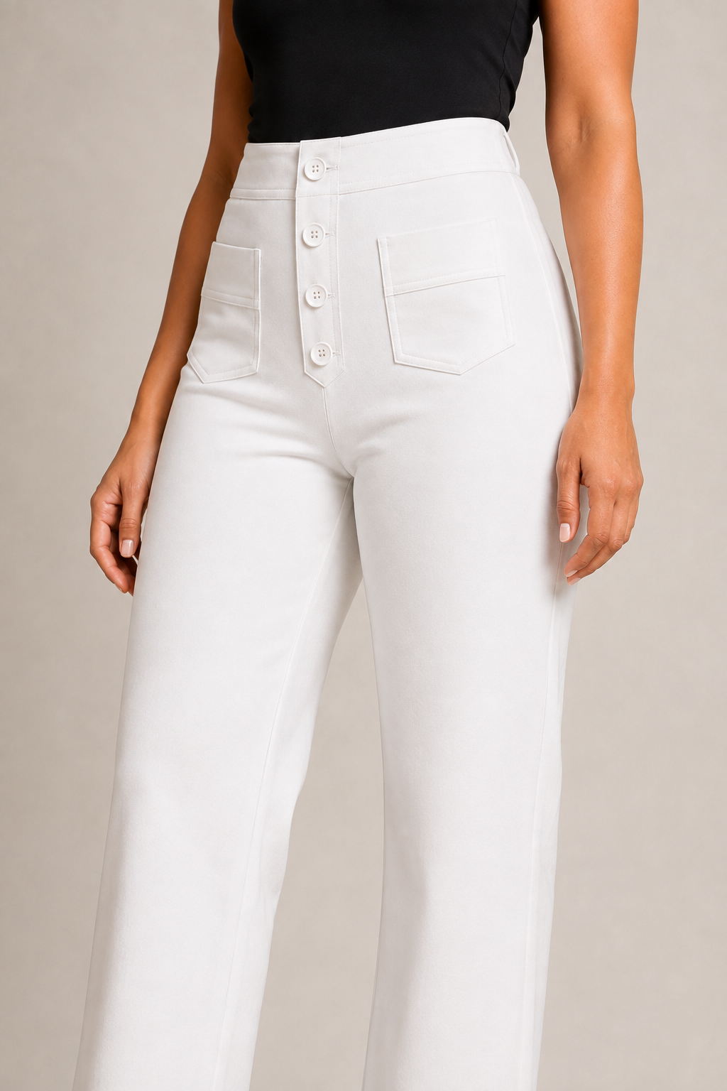Model-worn close-up of the white trousers showing the fine matte fabric texture and tonal stitching
