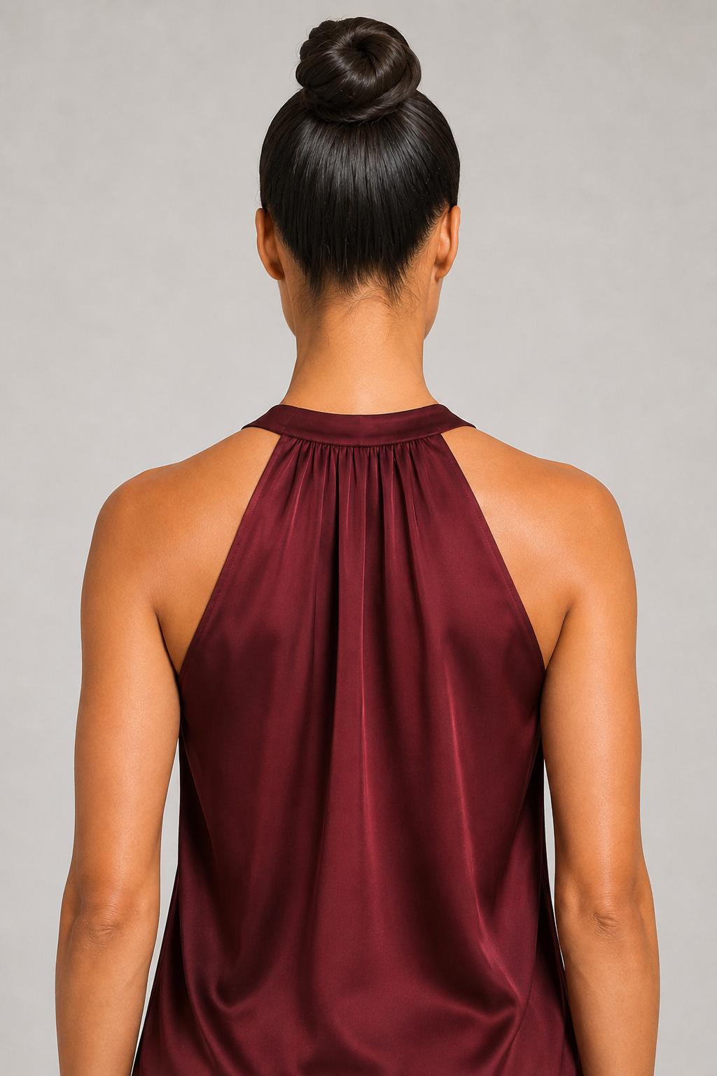 Back close-up of the burgundy blouse showing the broad halter neckline and draped back