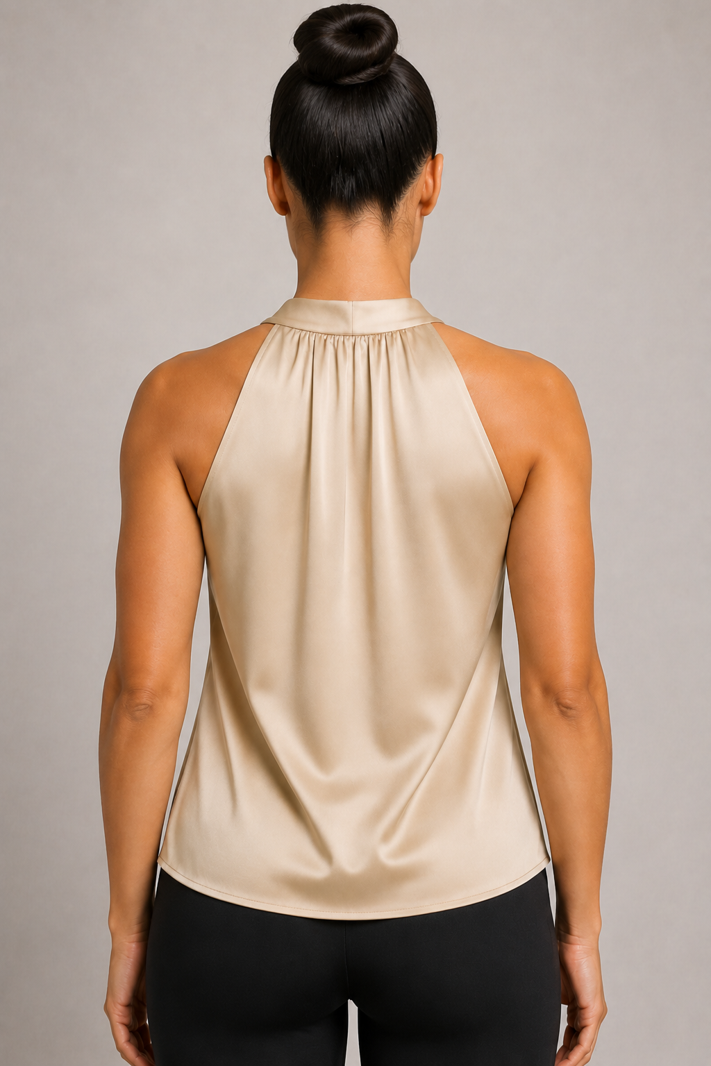 Back close-up of the champagne blouse showing the broad halter neckline and draped back