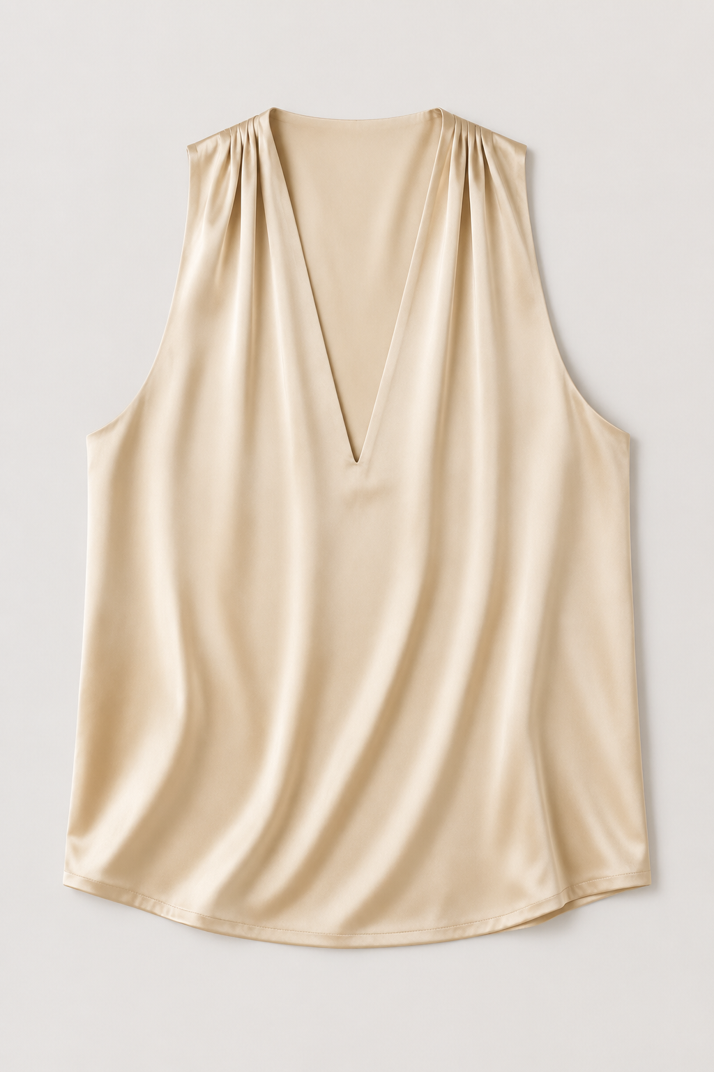 Flat-lay of the champagne draped halter-neck blouse