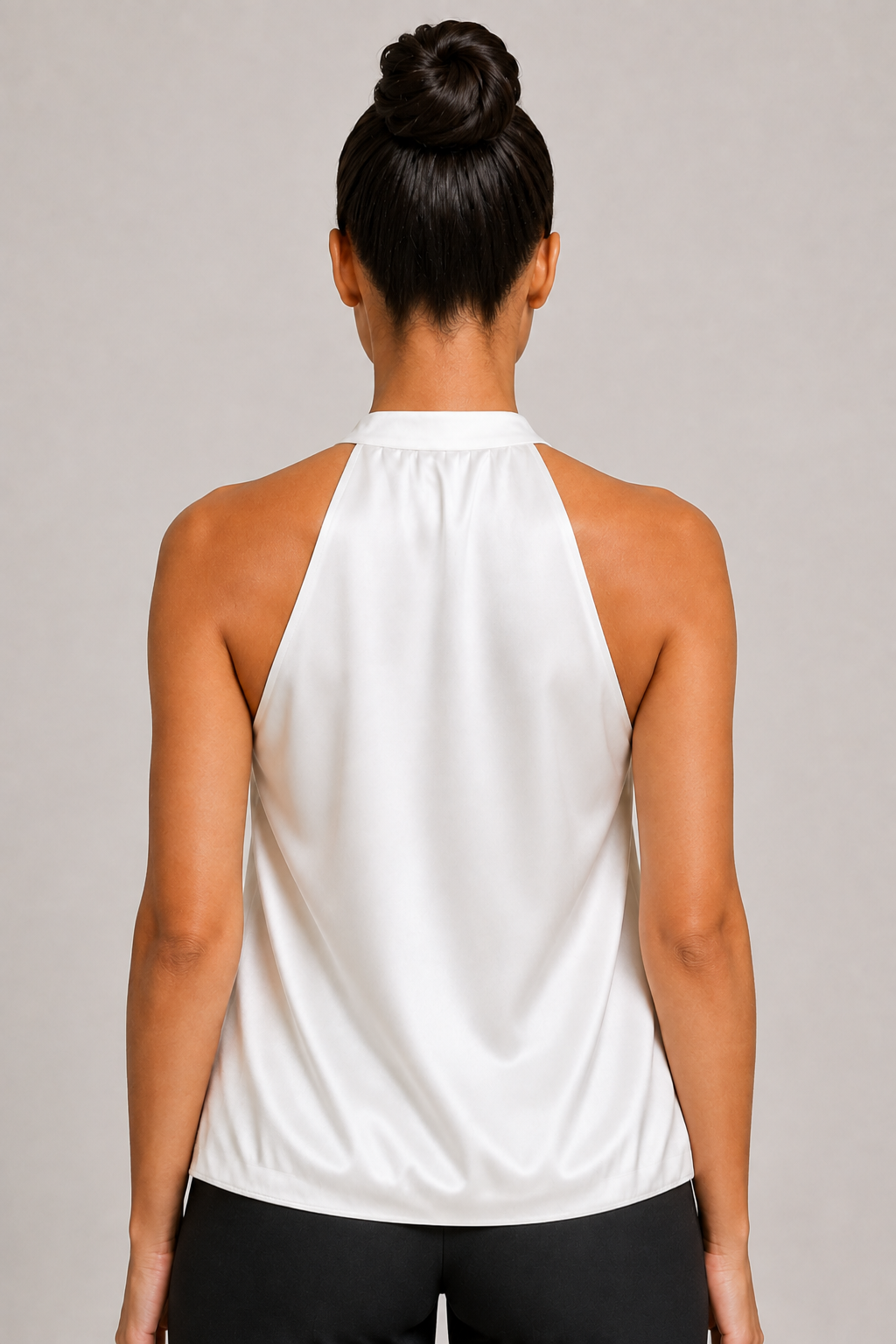 Back close-up of the white blouse showing the broad halter neckline and draped back