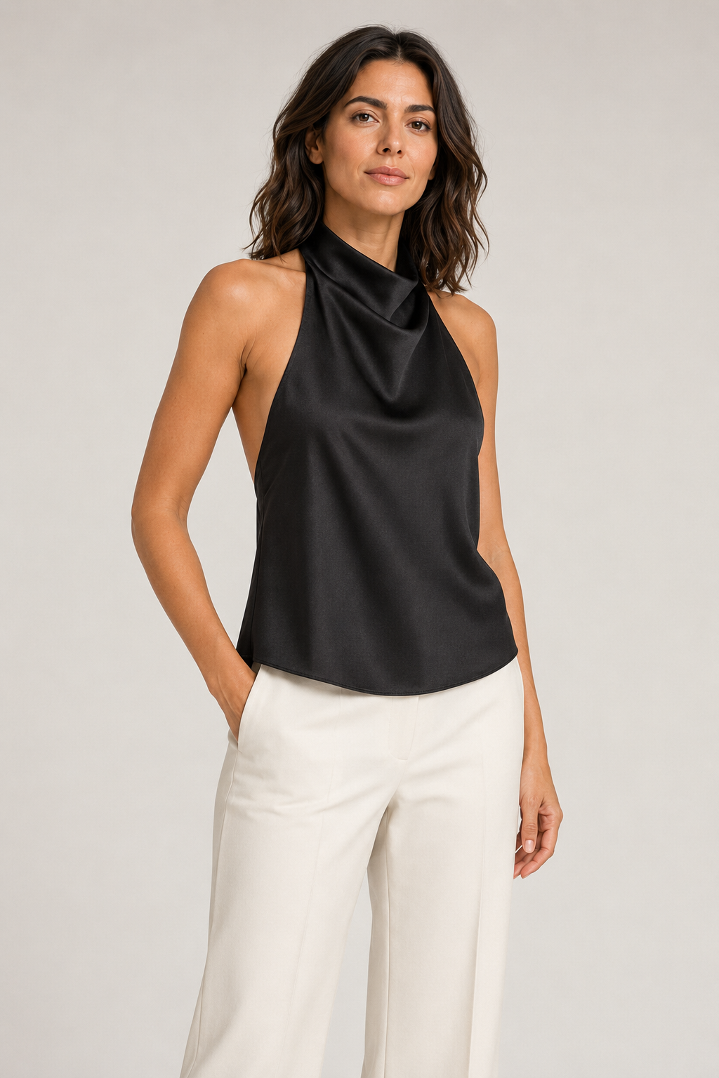 Woman wearing the black draped open-back halter top, front three-quarter view