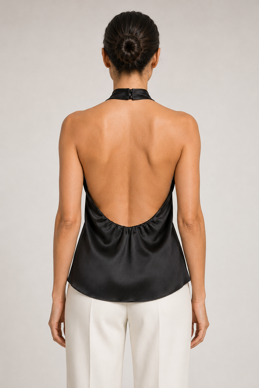 Back view of the black draped open-back halter top