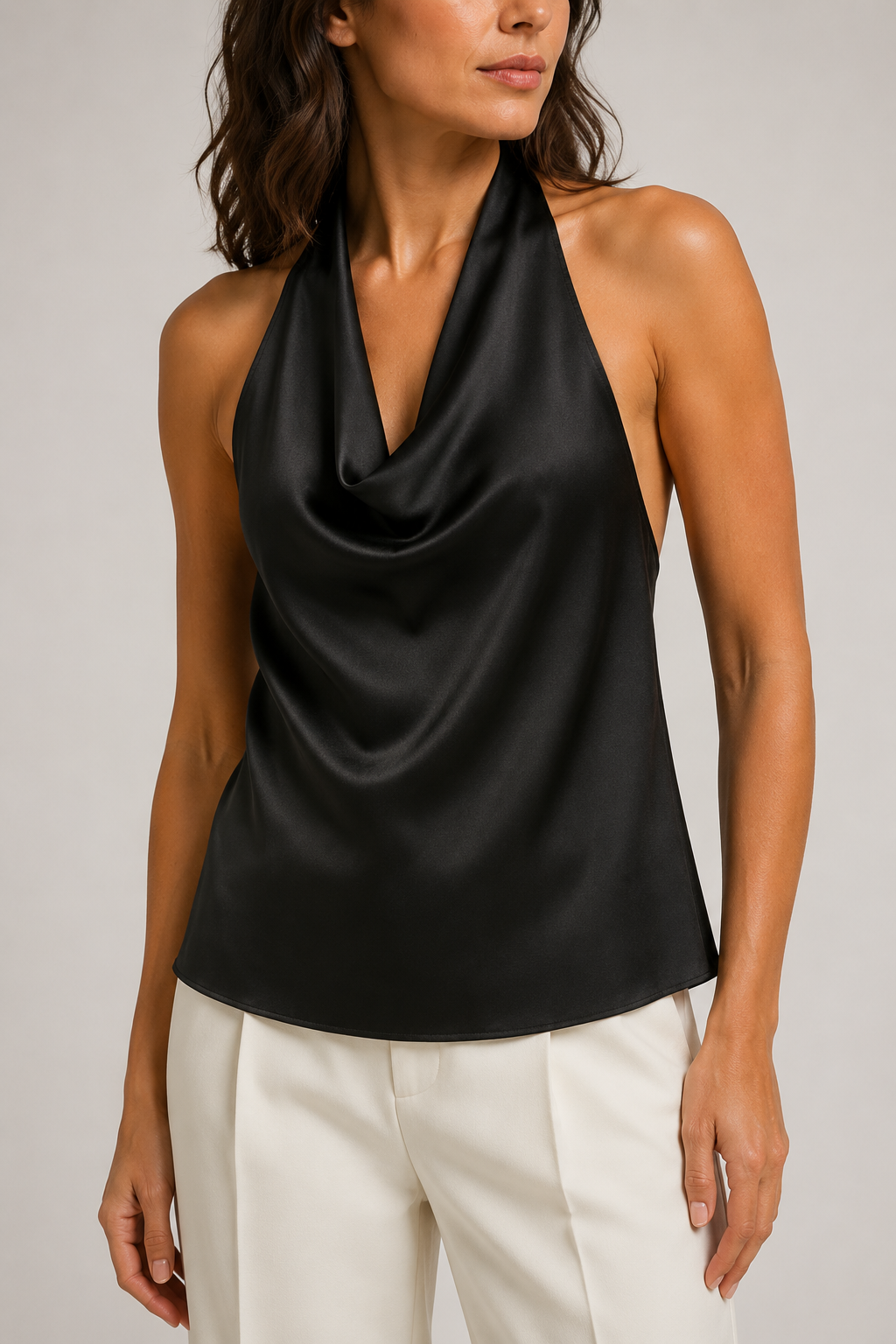 Model-worn close-up of the black halter top showing the smooth lustrous fabric and cowl drape