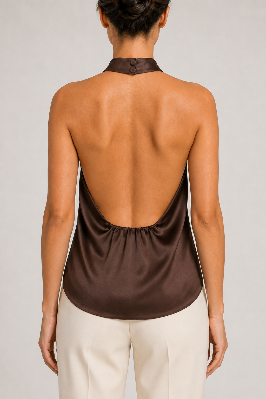 Back close-up of the brown halter top showing the neck fastening, open back and gathered lower edge