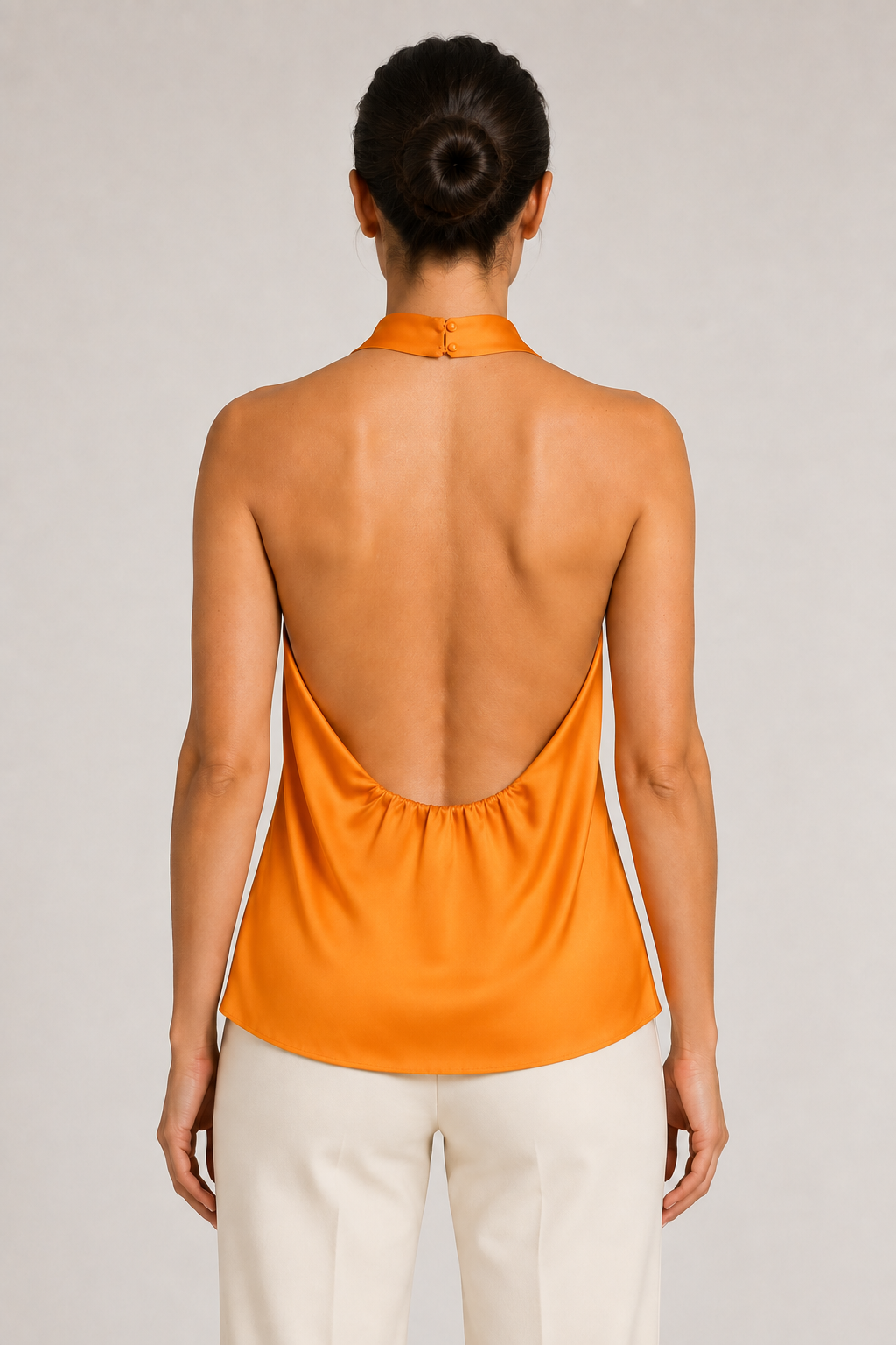 Back view of the orange draped open-back halter top