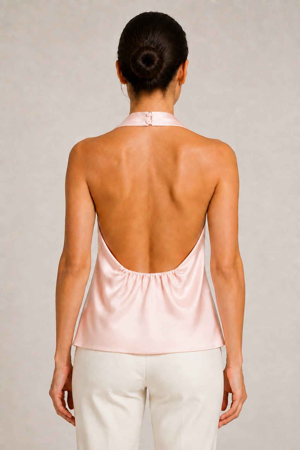 Back view of the pink draped open-back halter top