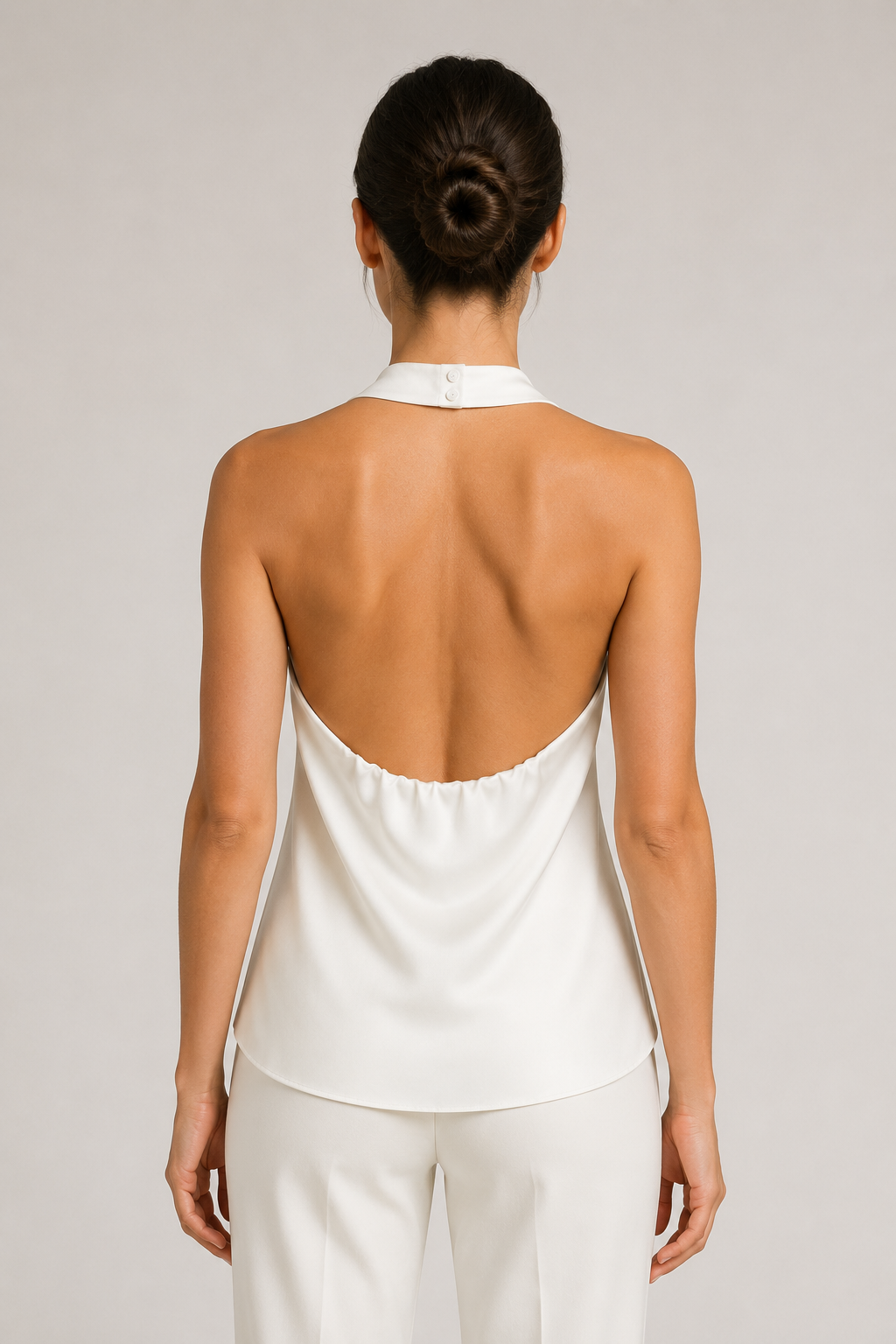 Back view of the white draped open-back halter top
