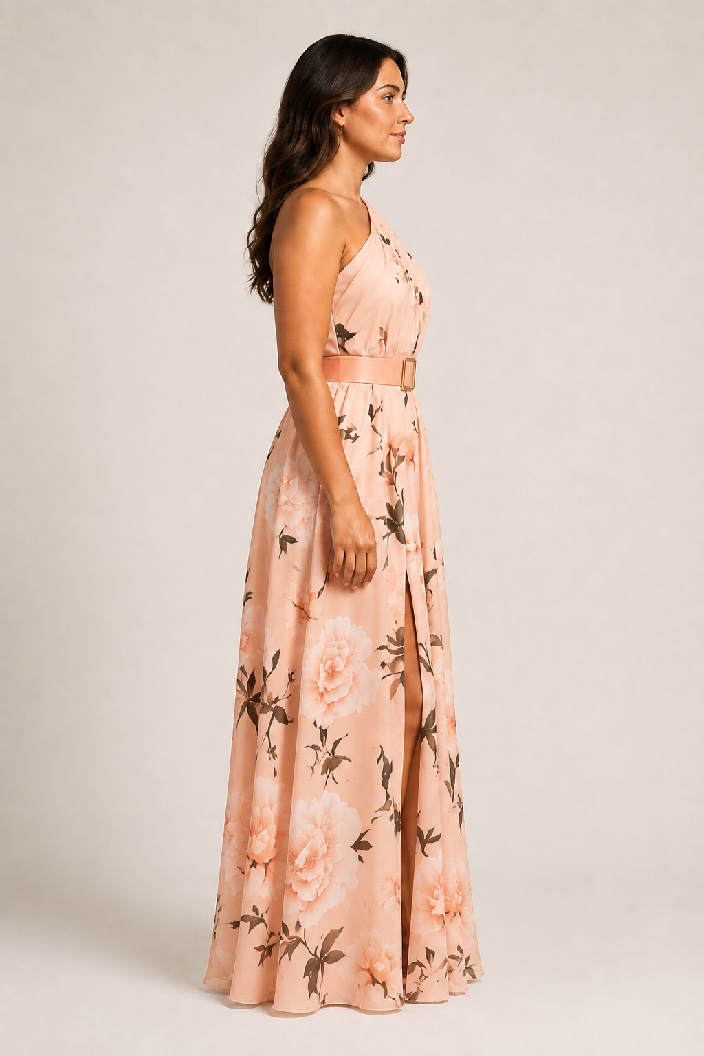 Side view of the pink floral one-shoulder maxi dress showing the belted waist and front split