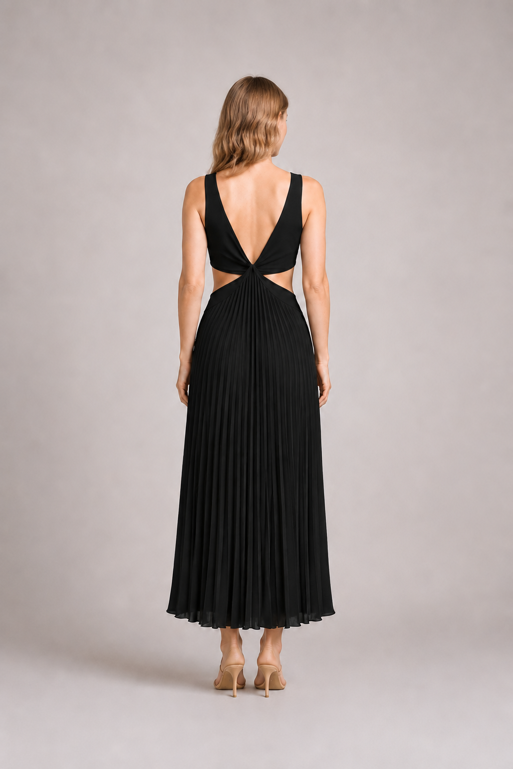 Back view of the black flowing pleated maxi dress