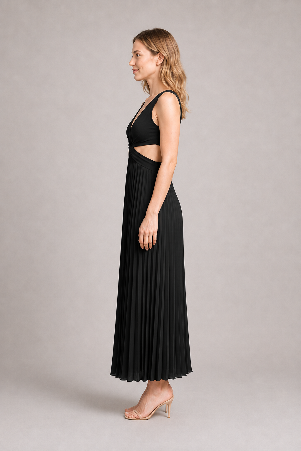 Side view of the black flowing pleated maxi dress