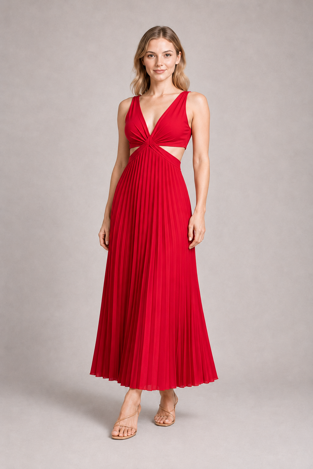 Woman wearing the red flowing pleated maxi dress, front three-quarter view