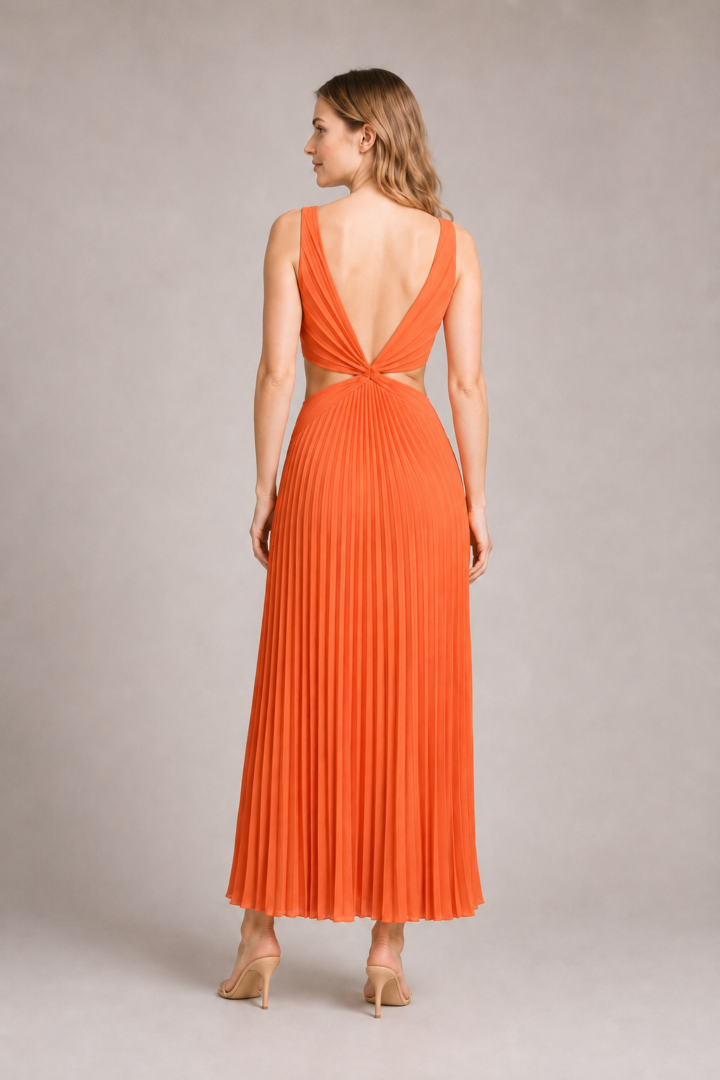 Back view of the watermelon-red flowing pleated maxi dress