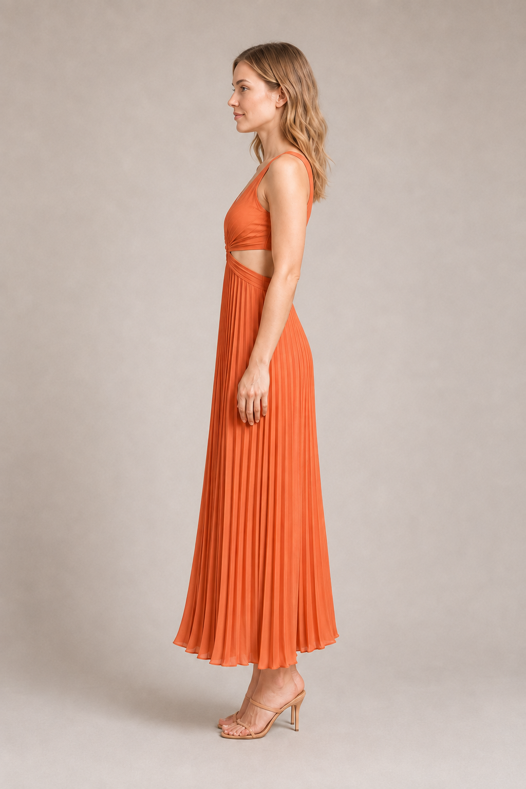 Side view of the watermelon-red flowing pleated maxi dress