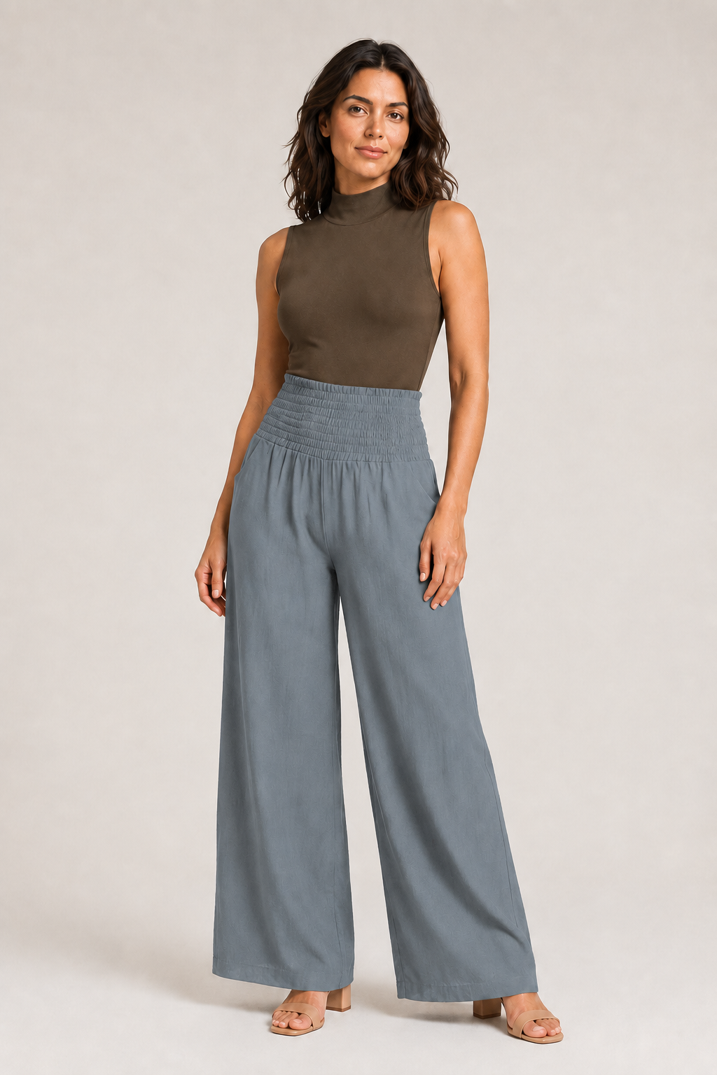 Woman wearing the gray high-waisted palazzo trousers, front three-quarter view