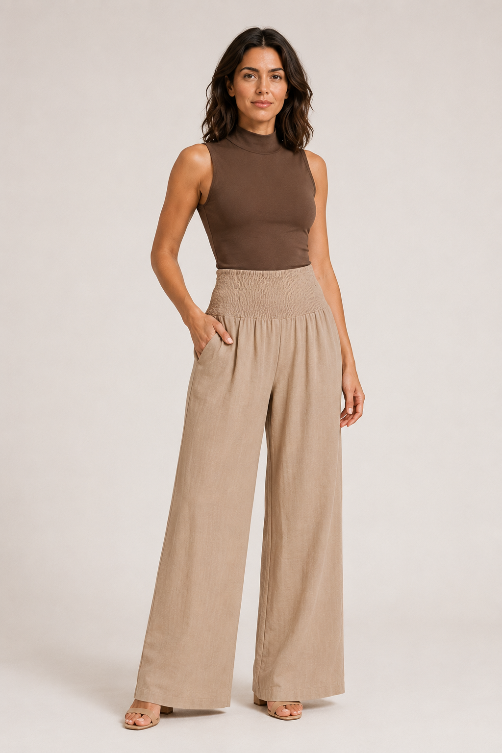 Woman wearing the khaki high-waisted palazzo trousers, front three-quarter view