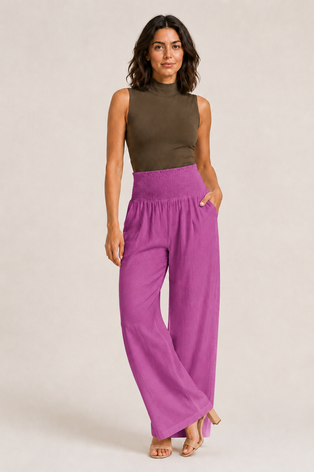 Woman wearing the magenta high-waisted palazzo trousers, front three-quarter view