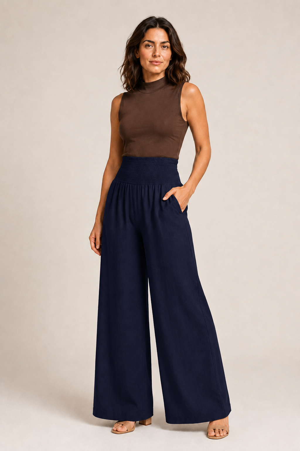 Woman wearing the navy blue high-waisted palazzo trousers, front three-quarter view