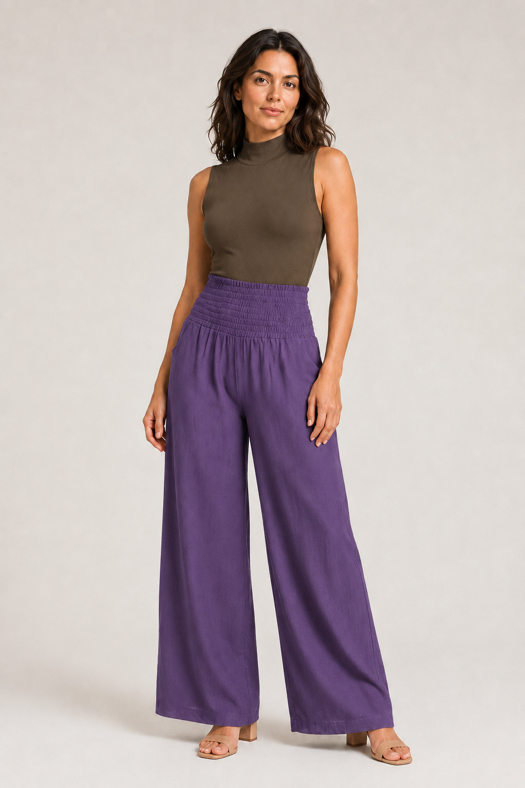 Woman wearing the purple high-waisted palazzo trousers, front three-quarter view