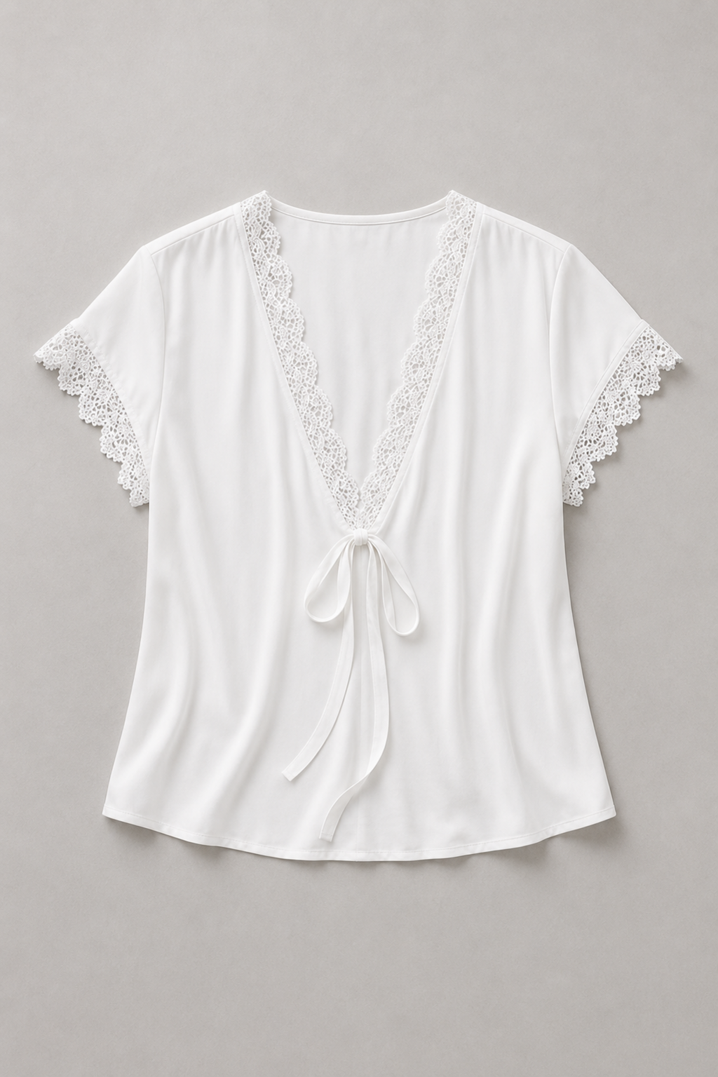 White lace-trim tie-front blouse flat lay