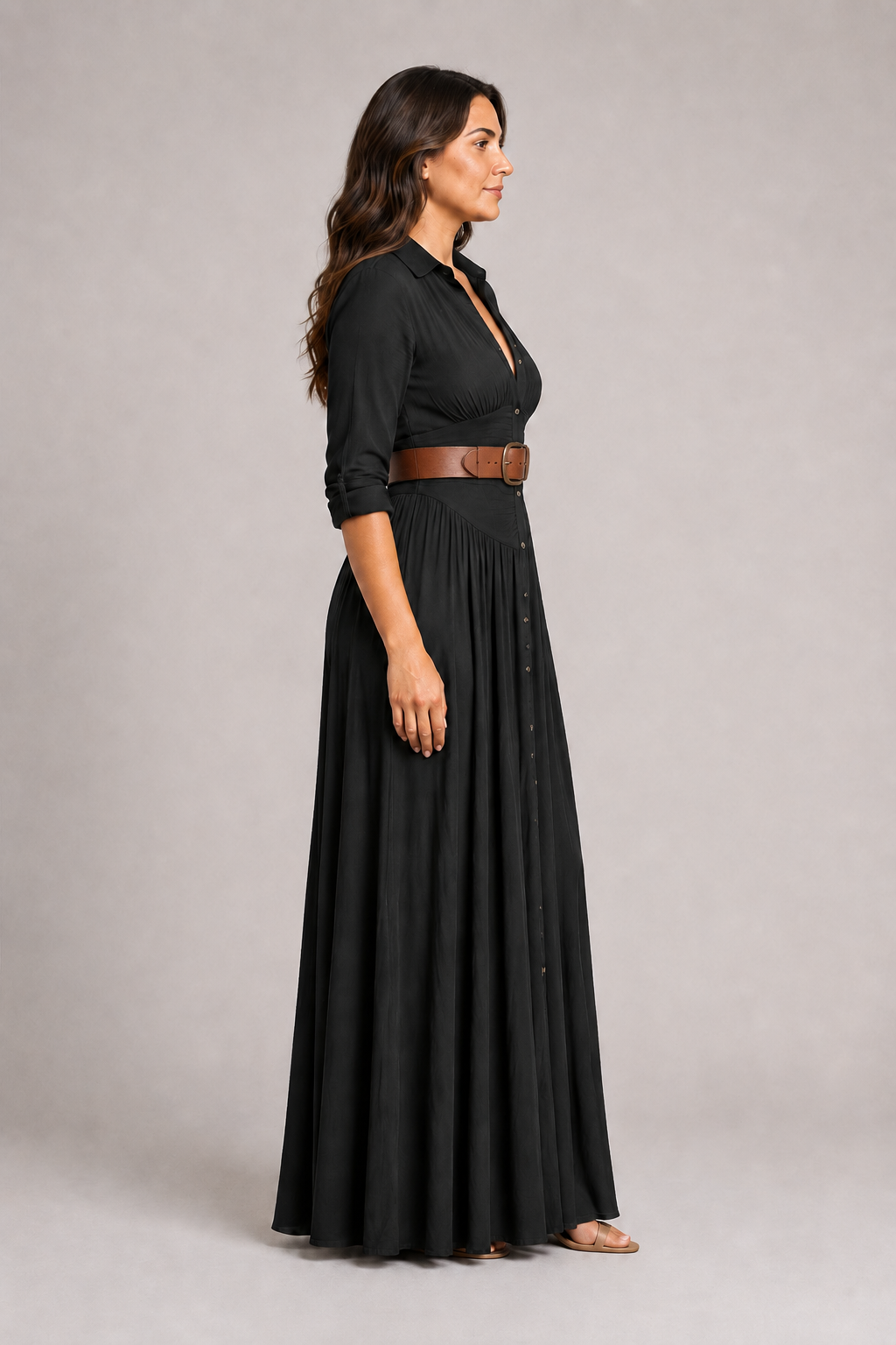 Black notched-collar pleated maxi dress with brown belt, side view