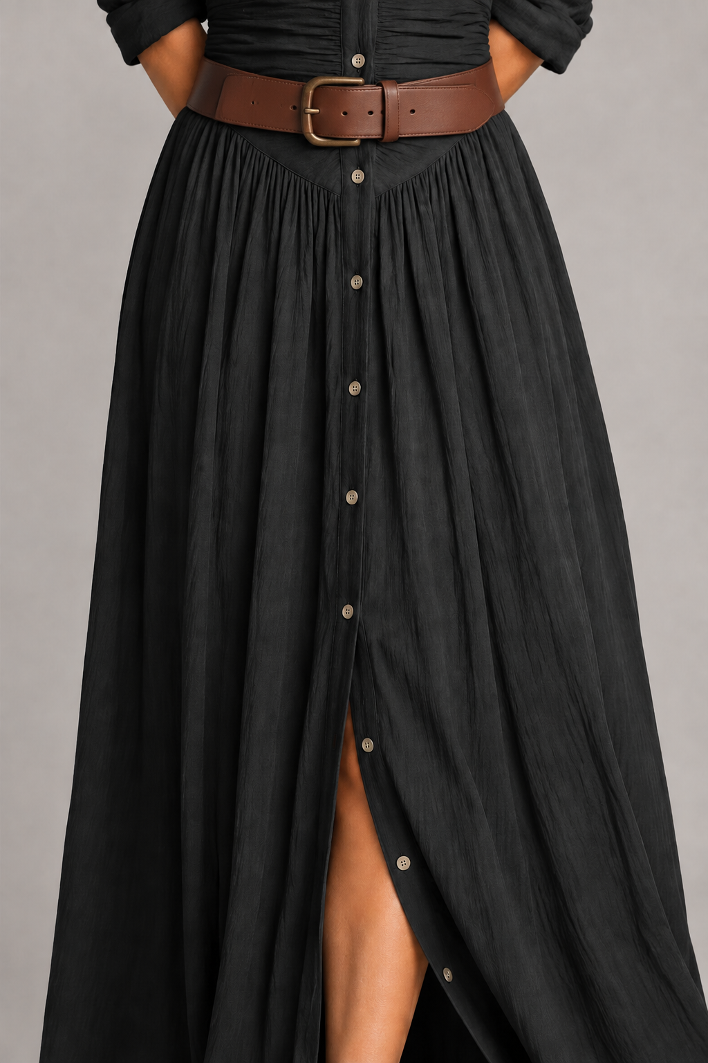 Black pleated maxi dress with brown belt, gathered-skirt fabric detail