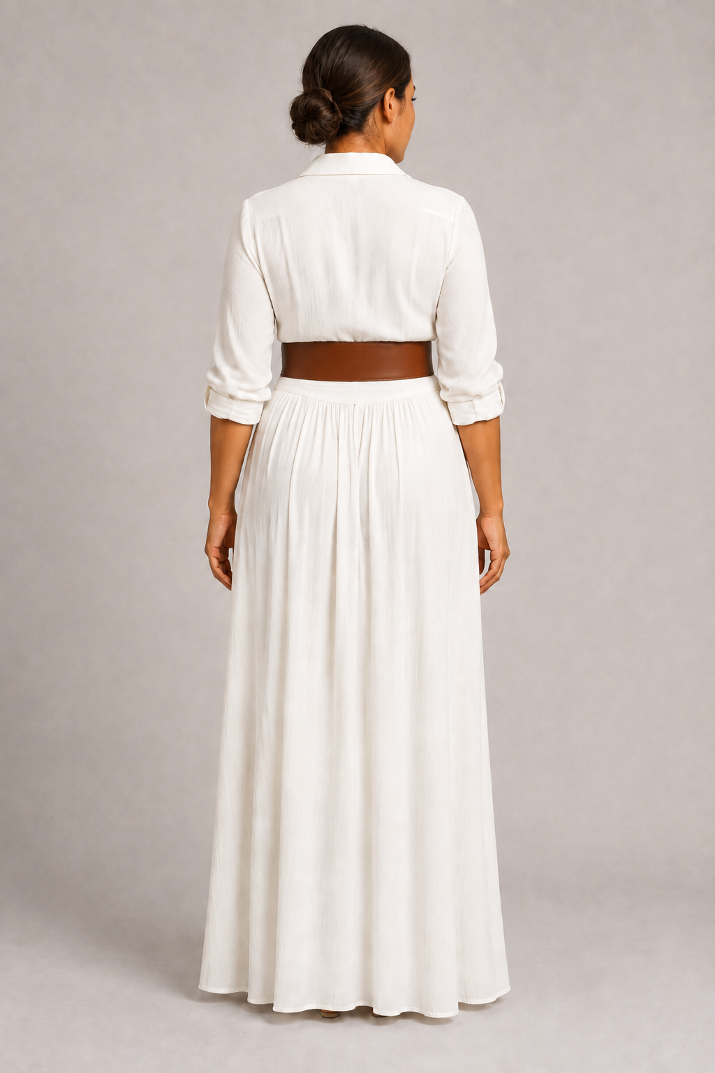 White notched-collar pleated maxi dress with brown belt, back view