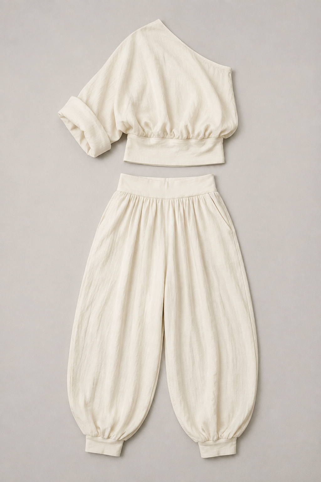 Ivory one-shoulder draped trouser set flat lay