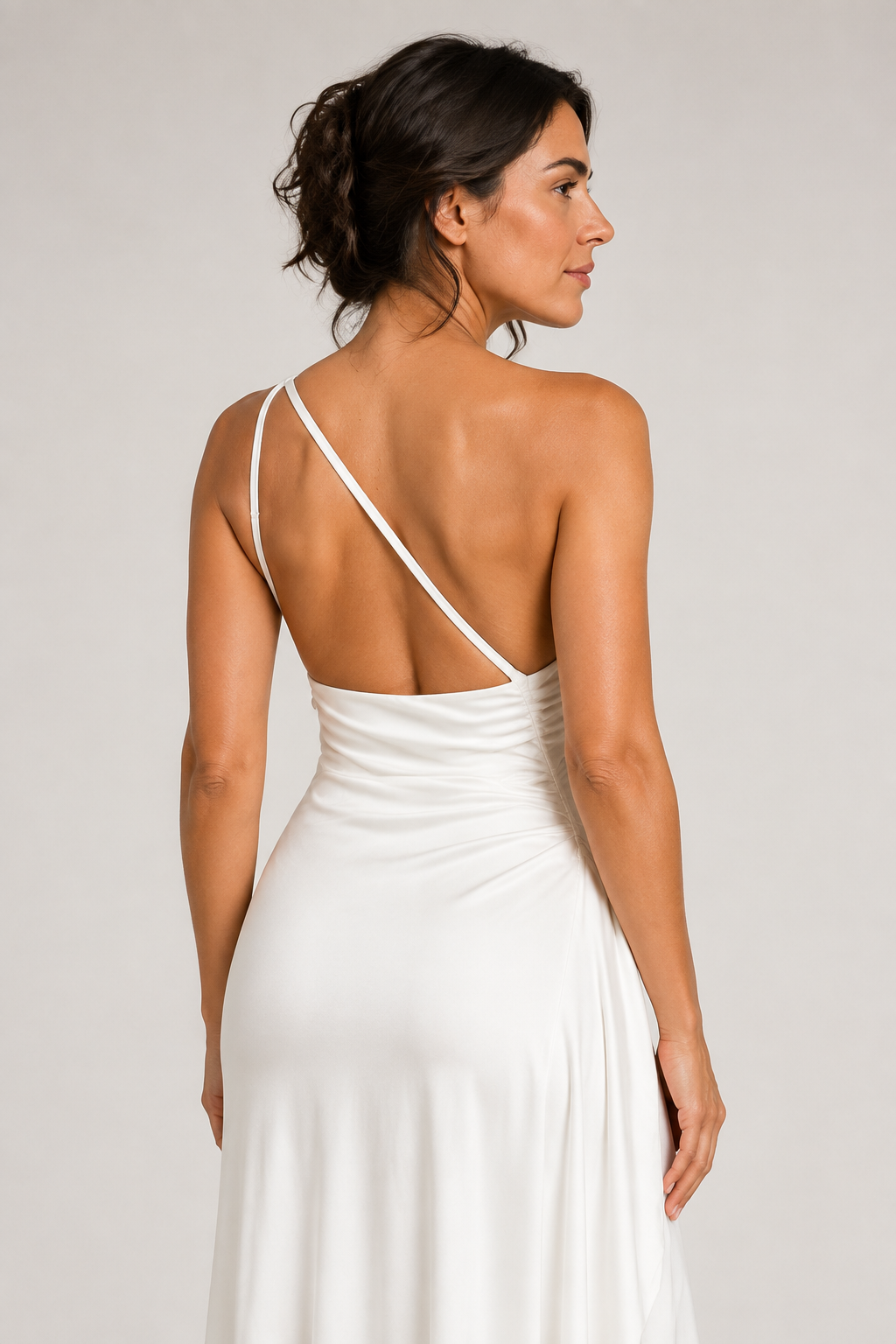 White one-shoulder flowing maxi dress, open-back strap construction detail