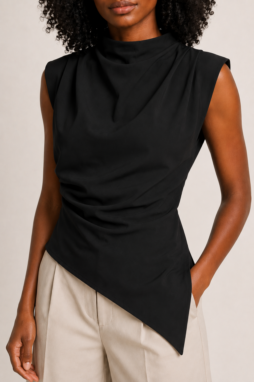 Black sleeveless draped asymmetric top, model-worn fabric detail