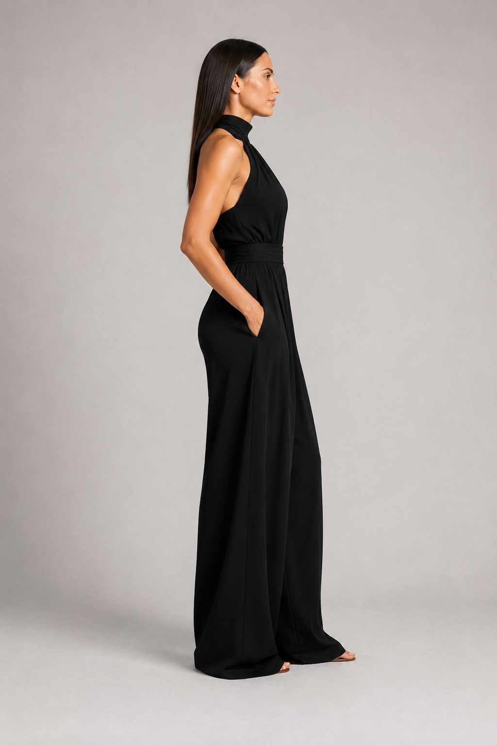 Black sleeveless halter-neck wide-leg jumpsuit, side view