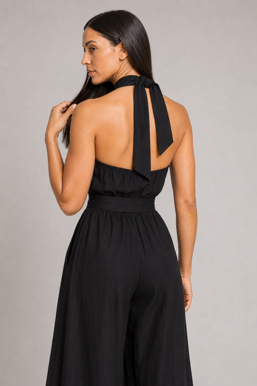 Black sleeveless halter-neck wide-leg jumpsuit, halter-back construction detail